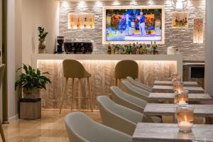 a dining room with a long table and chairs at Hotel Laurin in Lido di Jesolo
