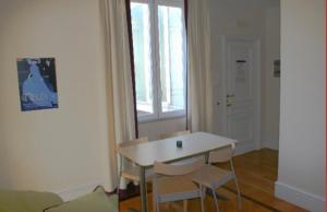 a white room with a table and chairs and a window at Residence gli Angioini srl in Naples