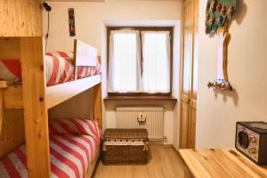 a room with two bunk beds and a window at Villa Antermont in Canazei