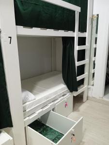 a white bunk bed with the bottom shelf and the bottom drawer at Fonte dos aloques in Porriño