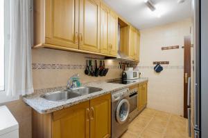 a kitchen with a sink and a washing machine at Smart flat close to Fuengirola beach - Ref 94 in Fuengirola