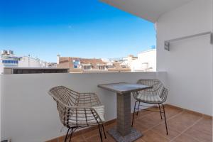 a table and chairs on a balcony with a view at Smart flat close to Fuengirola beach - Ref 94 in Fuengirola
