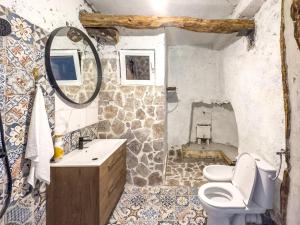 a bathroom with a toilet and a sink and a mirror at Villa Lisinj apartments in Dapčevići +29 photos