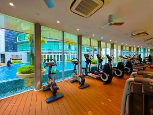 a gym with treadmills and ellipticals in a building at Vortex klcc in Kuala Lumpur