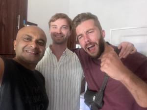 three men are posing for a picture together at PROMAX villa in Nuwara Eliya