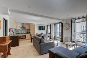 een open woonkamer en keuken in een appartement bij 303 Suite Simha - Superbe Appartement à Paris in Parijs