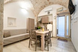 a kitchen and living room with a table and chairs at Casa Vita 49 in Ceglie Messapica +12 photos