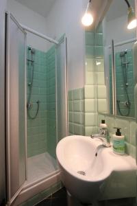 a bathroom with a sink and a shower at Barbadori Suite in Florence