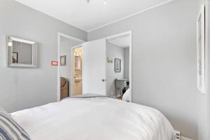 a white bedroom with a bed and a mirror at 127 Oakwood Hills in Oakwood Hills