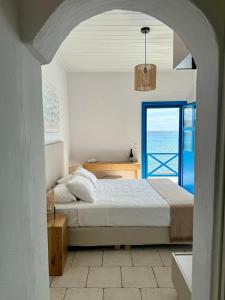 a bedroom with a bed and a view of the ocean at Agia Fotia Taverna in Kerames