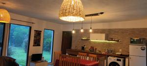 a kitchen with aendant light and a kitchen with a counter at Casa muy luminosa , 2 d in José Ignacio