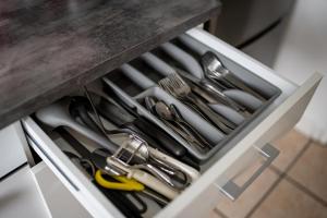 a drawer filled with utensils in a kitchen at ATRIUM - großzügige Wohnung LUDWIG79 in Ludwigshafen am Rhein