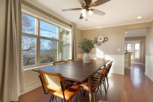 a dining room with a table with chairs and a ceiling fan at Fremont home with panoramic views near Woodland Zoo in Seattle