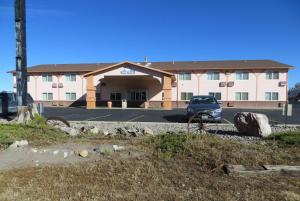 a building with a car parked in front of it at Days Inn by Wyndham Alamosa in Alamosa