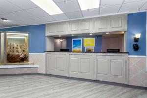 a waiting room with white cabinets and blue walls at Days Inn by Wyndham Melbourne in Melbourne