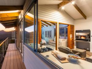 a balcony with a view of a living room at Landrani Farmstay in Oudtshoorn