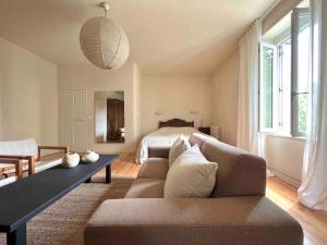 a living room with a couch and a bed at Maison Favori in Le Beugnon +30 photos