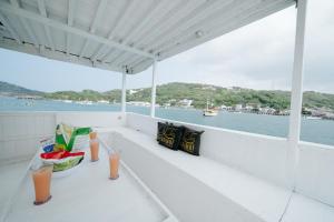 a balcony with a table and drinks on a boat at Arimbi Liveaboard in Labuan Bajo