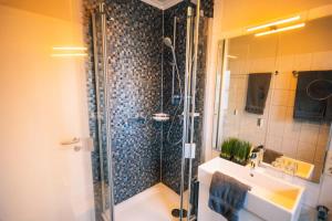 a bathroom with a shower and a sink at Haus Jelena Appartement 1 in Borkum