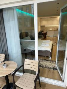 a room with a bed and a table and chairs at Luxury Apartment Tirana Centre in Tirana