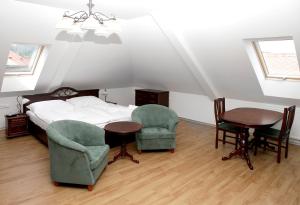 - une chambre avec un lit, deux chaises et une table dans l'établissement Pivovar a restaurace Faltus, à Česká Třebová