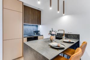 a kitchen with a table with two plates on it at Sea view 16 floor premium apartment in Tallinn