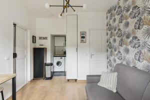 a living room with a couch and a kitchen at 821 Suite Licorne - Superb apartment in Les Lilas