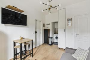 a living room with a couch and a table at 821 Suite Licorne - Superb apartment in Les Lilas