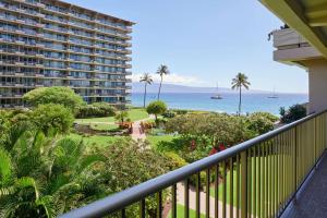 a balcony with a view of the ocean and a resort at Aston at The Whaler on Kaanapali Beach in Lahaina
