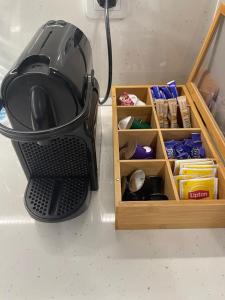 a blender sitting on a counter next to a wooden drawer at Nova City Apartments in Varna City