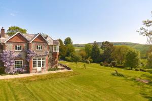 a house in a field with green grass at Lordington Park in Chichester