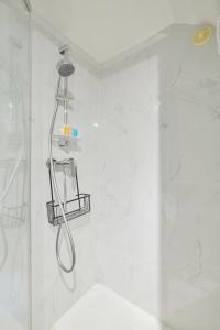 a shower with a shower head in a bathroom at 317 Suite Martin - Superb apartment in Paris in Paris