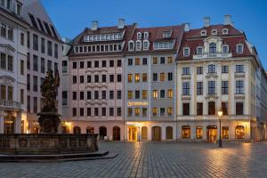 a group of buildings in a square with a statue at Amedia Plaza Dresden in Dresden