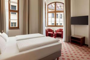 a hotel room with a bed and a window at Amedia Plaza Dresden in Dresden