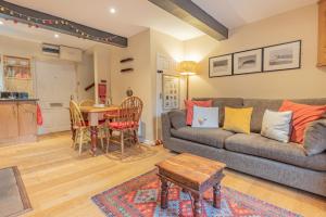 a living room with a couch and a table at Millpond Cottage in Holmfirth