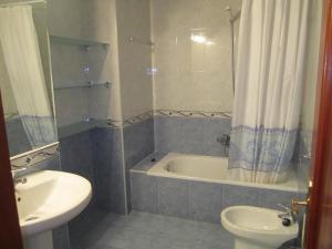 a bathroom with a tub and a toilet and a sink at CASA MANUELA in Suances +9 photos