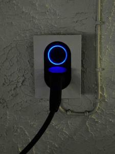a blue light is attached to a wall at My Sweet Home in Fauske