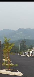 a street with a tree on the side of the road at Family Homstay kulim Hitech in Kampong Sira