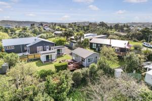 an aerial view of a suburb with houses at The Shed - Raglan Holiday Home in Raglan