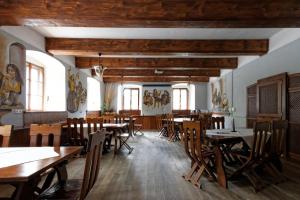 a dining room with wooden tables and chairs at Hotel Jaškovská Krčma in Horní Těrlicko