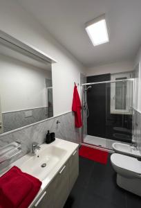 a bathroom with a sink and a toilet and a shower at Casa degli Ori by the city in Prato