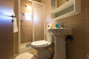 a bathroom with a toilet and a sink and a shower at Taipas Guest House in Porto +36 photos
