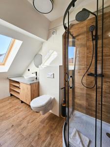 a bathroom with a shower and a toilet and a sink at visit baltic - Promenada Studio Wydma in Świnoujście