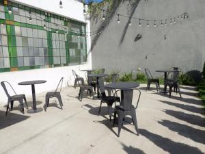 a group of tables and chairs in front of a building at HOTEL ROMA DE TANDIL in Tandil