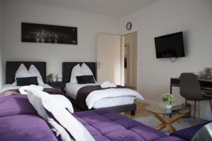 een hotelkamer met 2 bedden en een bank bij Timeless Apartment Bremen-Neustadt in Bremen