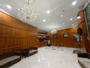 a lobby with wooden walls and a chandelier at Albergo Hotel in Baguio
