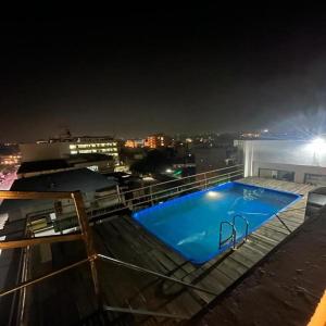 a swimming pool on top of a building at night at Hotel GVS-24 CLUB, Rooftop Cafe! swimming pool! Karaoke Music! in Udaipur