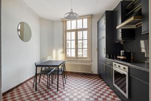 a kitchen with a table and some chairs in it at The Workspace w/Free Parking in Antwerp