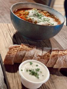 a bowl of soup with bread and a bowl of dip at Quality Hotel Grand Royal in Narvik