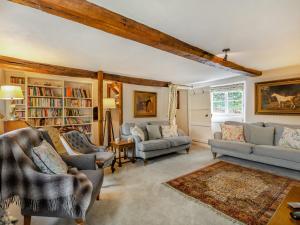 a living room with couches and chairs and a book shelf at 4 Bed in Near and Far Sawrey LLH02 in Near Sawrey